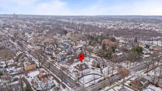 an aerial view of house with yard and mountain view in back