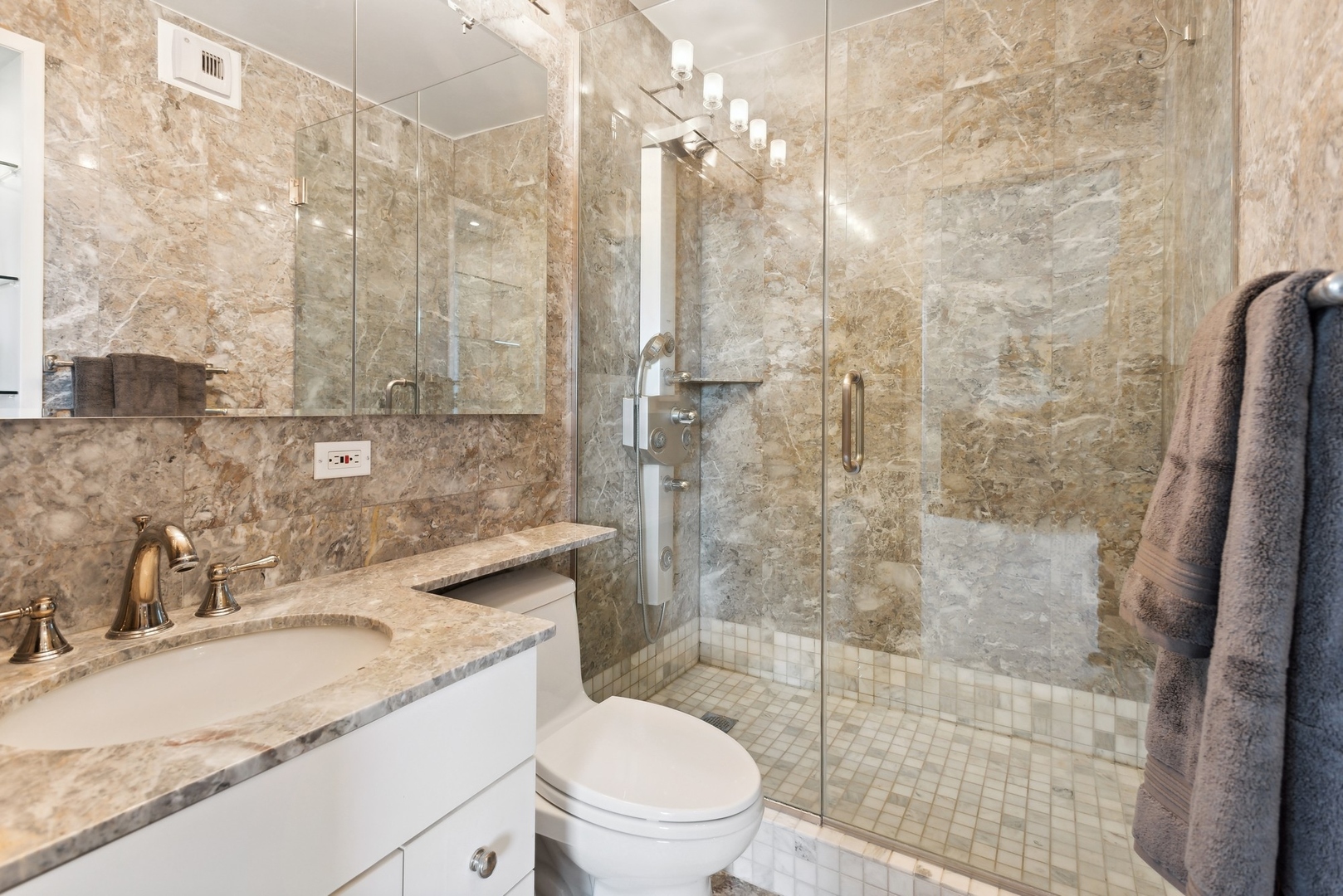 1310 North Ritchie Court, Unit 12BC Chicago, IL 60610 - Photo 22 of 38 a bathroom with a granite countertop sink a toilet and shower