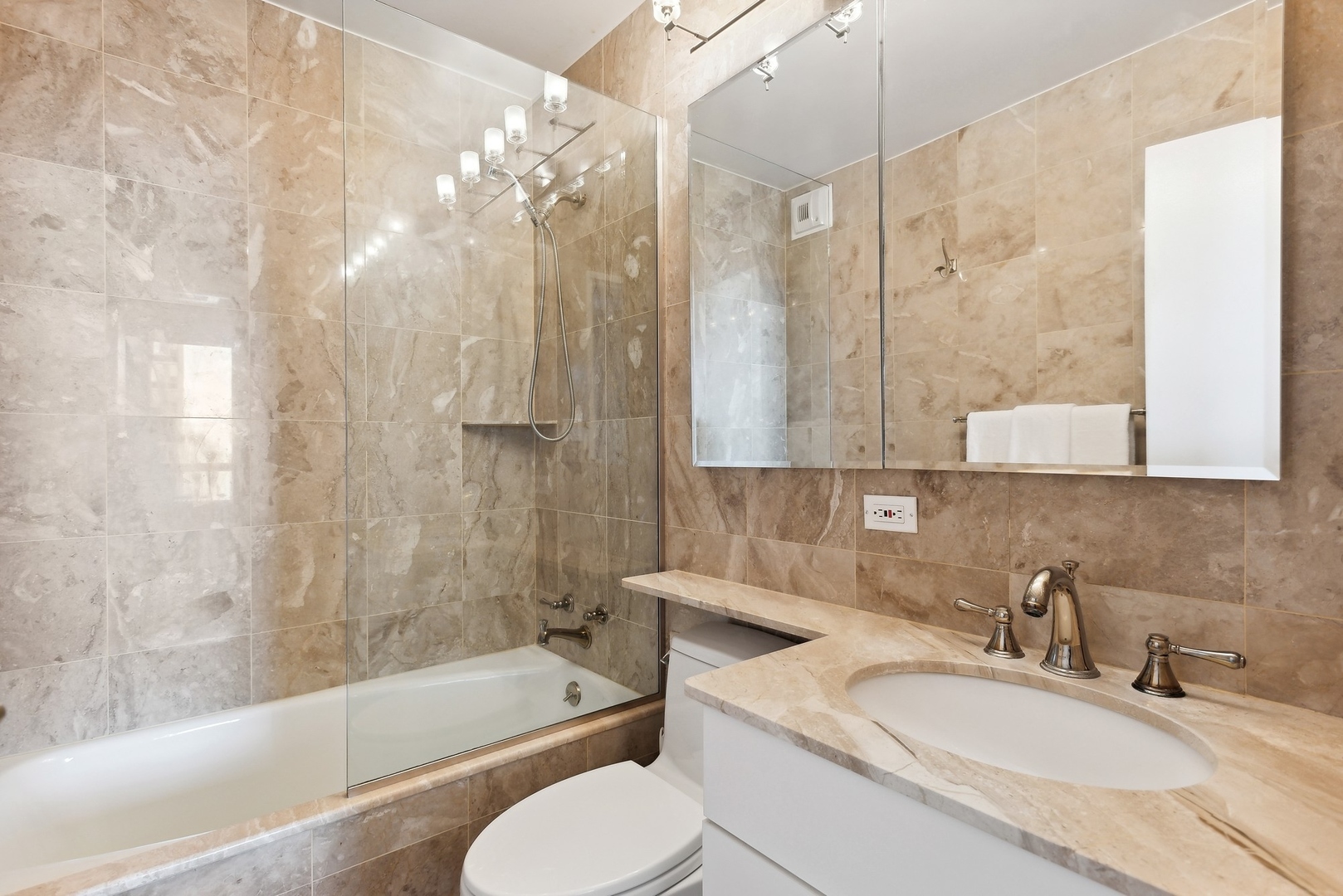 1310 North Ritchie Court, Unit 12BC Chicago, IL 60610 - Photo 23 of 38 a bathroom with a granite countertop sink a toilet and bathtub