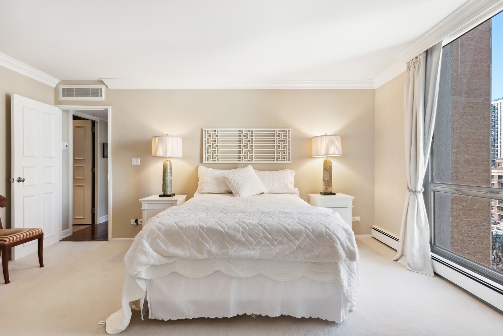 1310 North Ritchie Court, Unit 12BC Chicago, IL 60610 - Photo 27 of 38 a spacious bedroom with a bed and a window