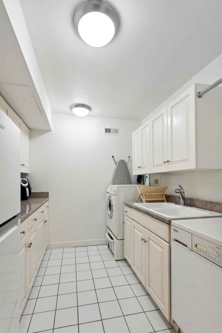 1310 North Ritchie Court, Unit 12BC Chicago, IL 60610 - Photo 30 of 38 a kitchen with a sink stove and cabinets
