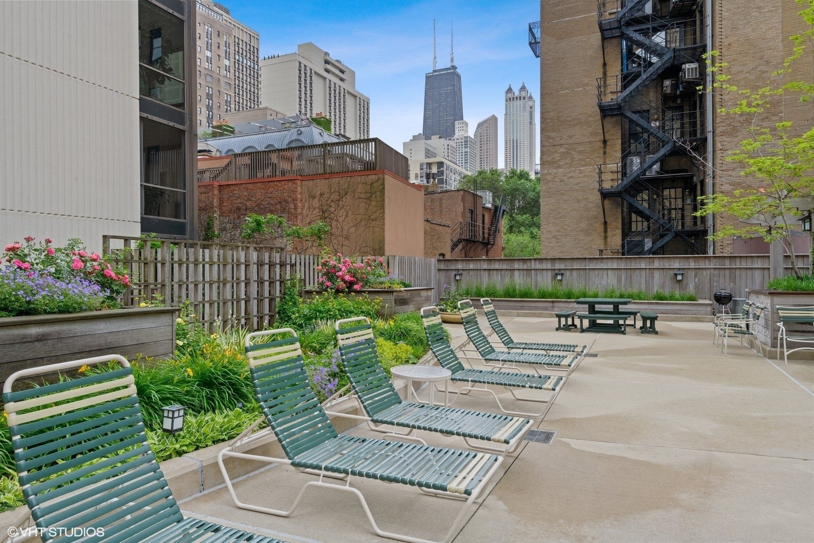 1310 North Ritchie Court, Unit 12BC Chicago, IL 60610 - Photo 34 of 38 a view of a patio with couches table and chairs and potted plants