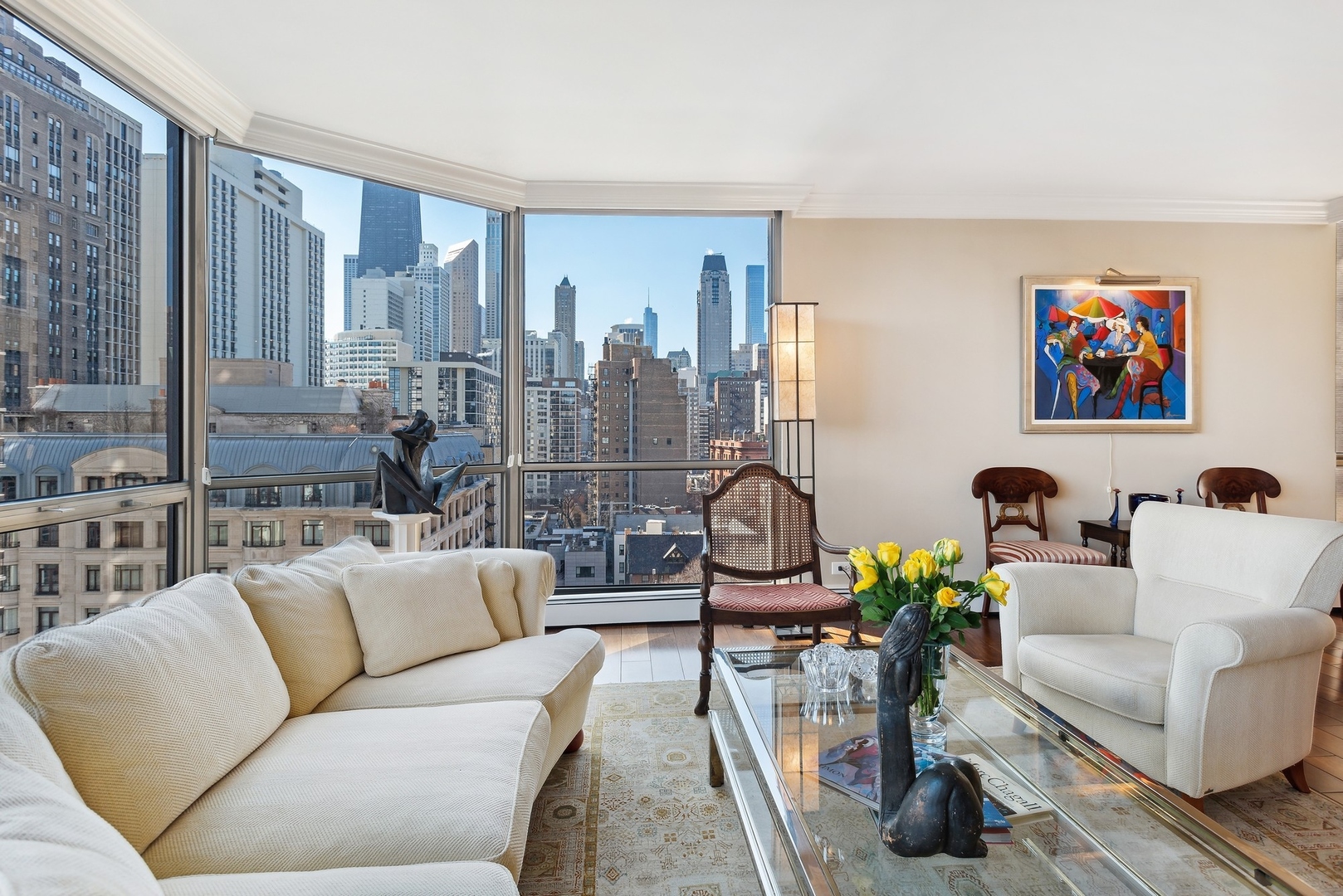 1310 North Ritchie Court, Unit 12BC Chicago, IL 60610 - Photo 6 of 38 a living room with furniture a chandelier and a floor to ceiling window