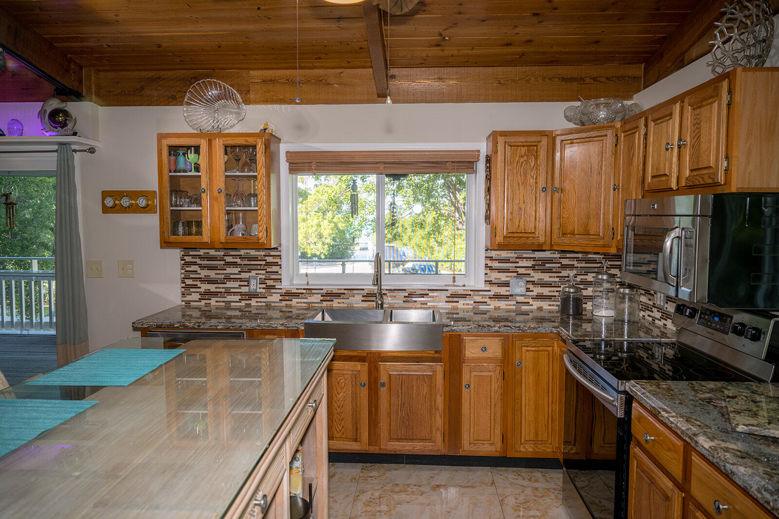 21 Sunset Road Key Largo, FL 33037 - Photo 19 of 121 a kitchen with stainless steel appliances granite countertop a stove a sink and a microwave