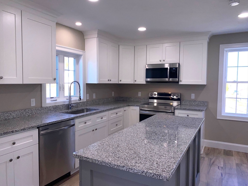 152 West Main Street, Unit A Millbury, MA 01527 - Photo 14 of 33 a kitchen with granite countertop wooden cabinets and a granite counter tops