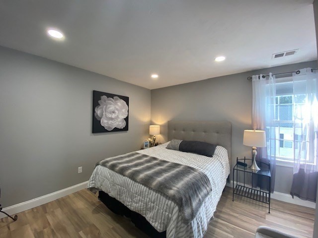 152 West Main Street, Unit A Millbury, MA 01527 - Photo 20 of 33 a bedroom with a large bed and a lamp