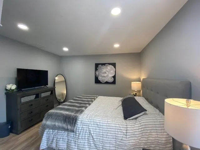 a bedroom with a bed and a flat screen tv
