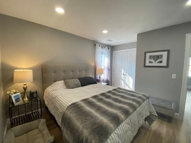 a bedroom with a bed and a mirror