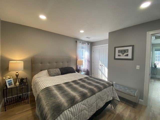 152 West Main Street, Unit A Millbury, MA 01527 - Photo 23 of 33 a bedroom with a bed and wooden floor