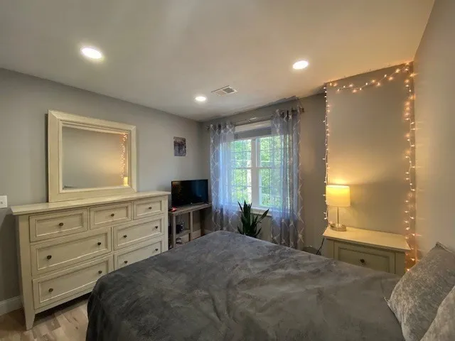 a bedroom with a bed and a dresser