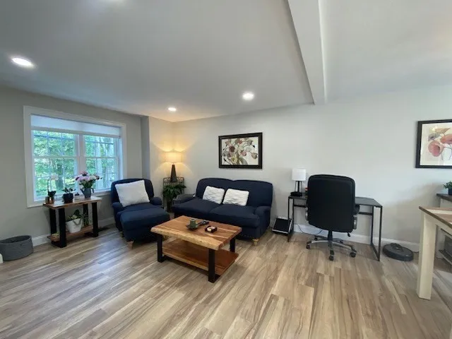 a living room with furniture and wooden floor