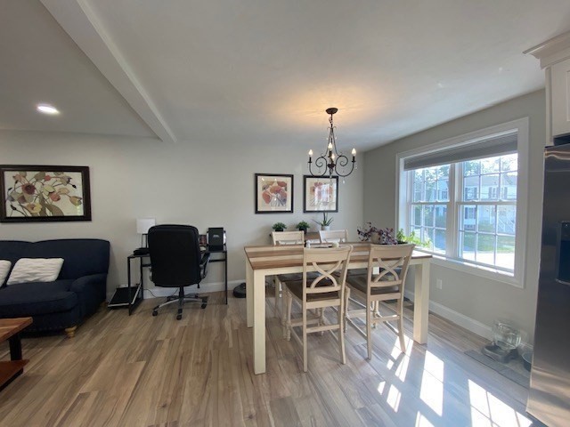 152 West Main Street, Unit A Millbury, MA 01527 - Photo 8 of 33 a view of a dining room with furniture a rug and wooden floor