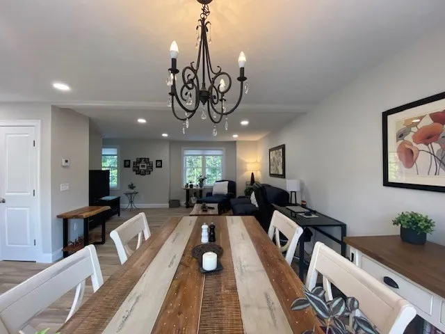 a view of a dining room with furniture wooden floor and a chandelier