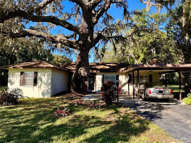 a view of a car park in front of a house