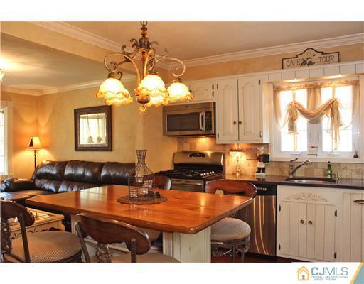 10 Moraine Road Edison, NJ 08820 - Photo 14 of 25 a kitchen with a sink refrigerator and cabinets
