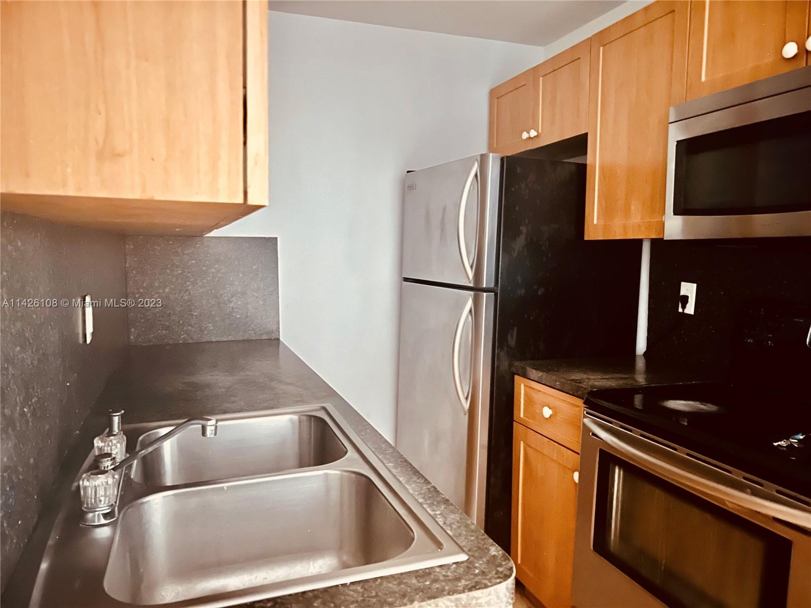 Flamingo-Lummus Miami Beach, FL 33139 - Photo 1 of 13 a kitchen with a refrigerator stove and microwave