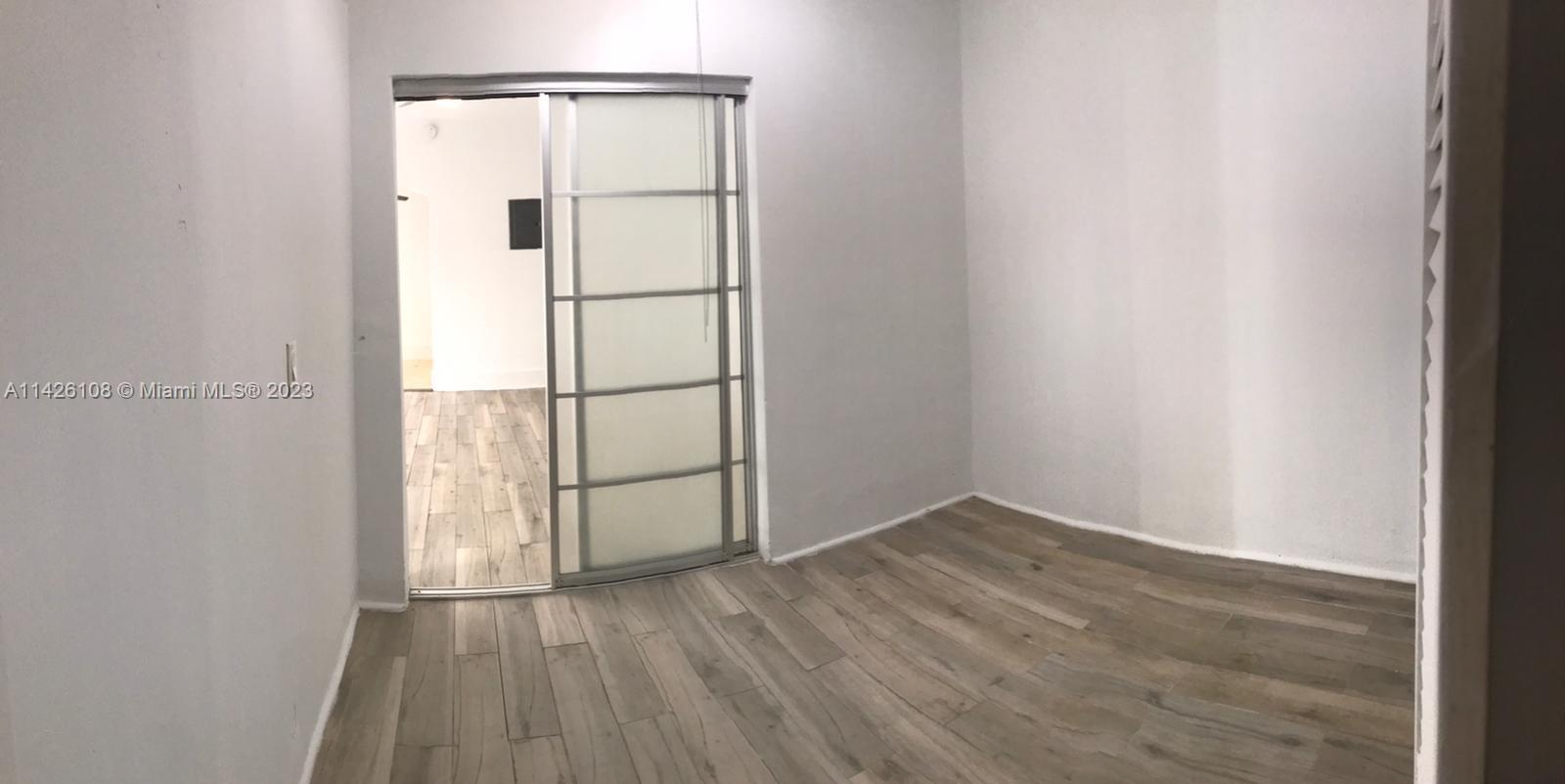 Flamingo-Lummus Miami Beach, FL 33139 - Photo 11 of 13 an empty room with wooden floor and mirror
