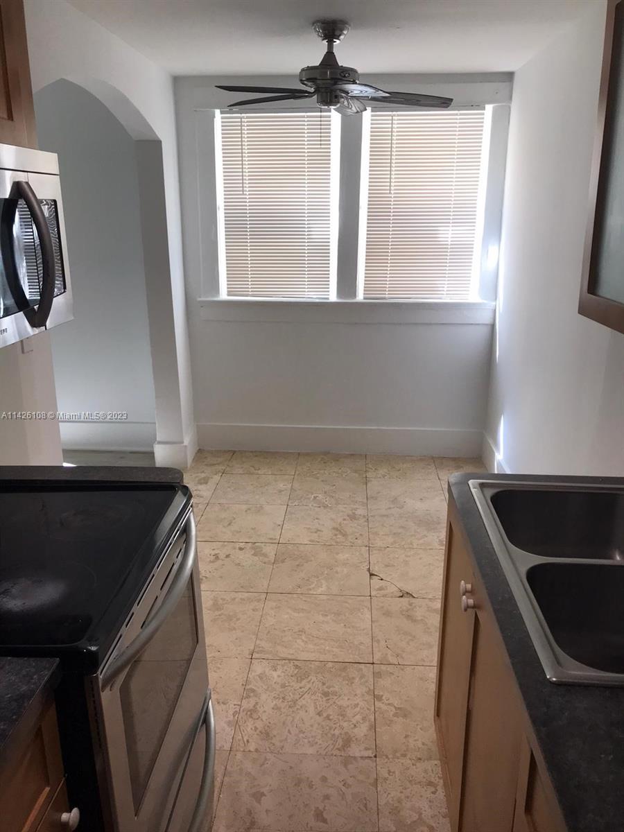 Flamingo-Lummus Miami Beach, FL 33139 - Photo 3 of 13 a kitchen with a sink a refrigerator and window