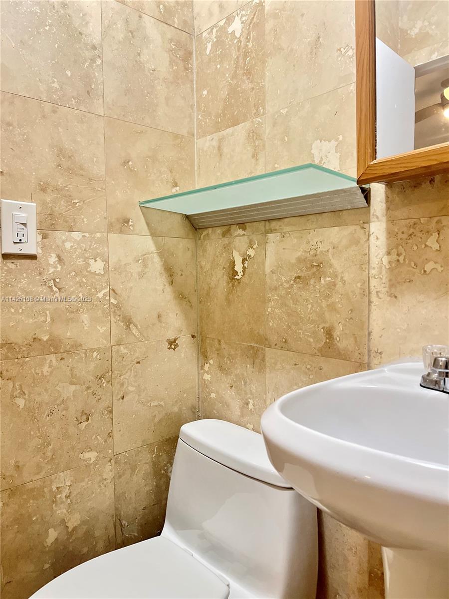 Flamingo-Lummus Miami Beach, FL 33139 - Photo 8 of 13 a bathroom with a sink and a toilet