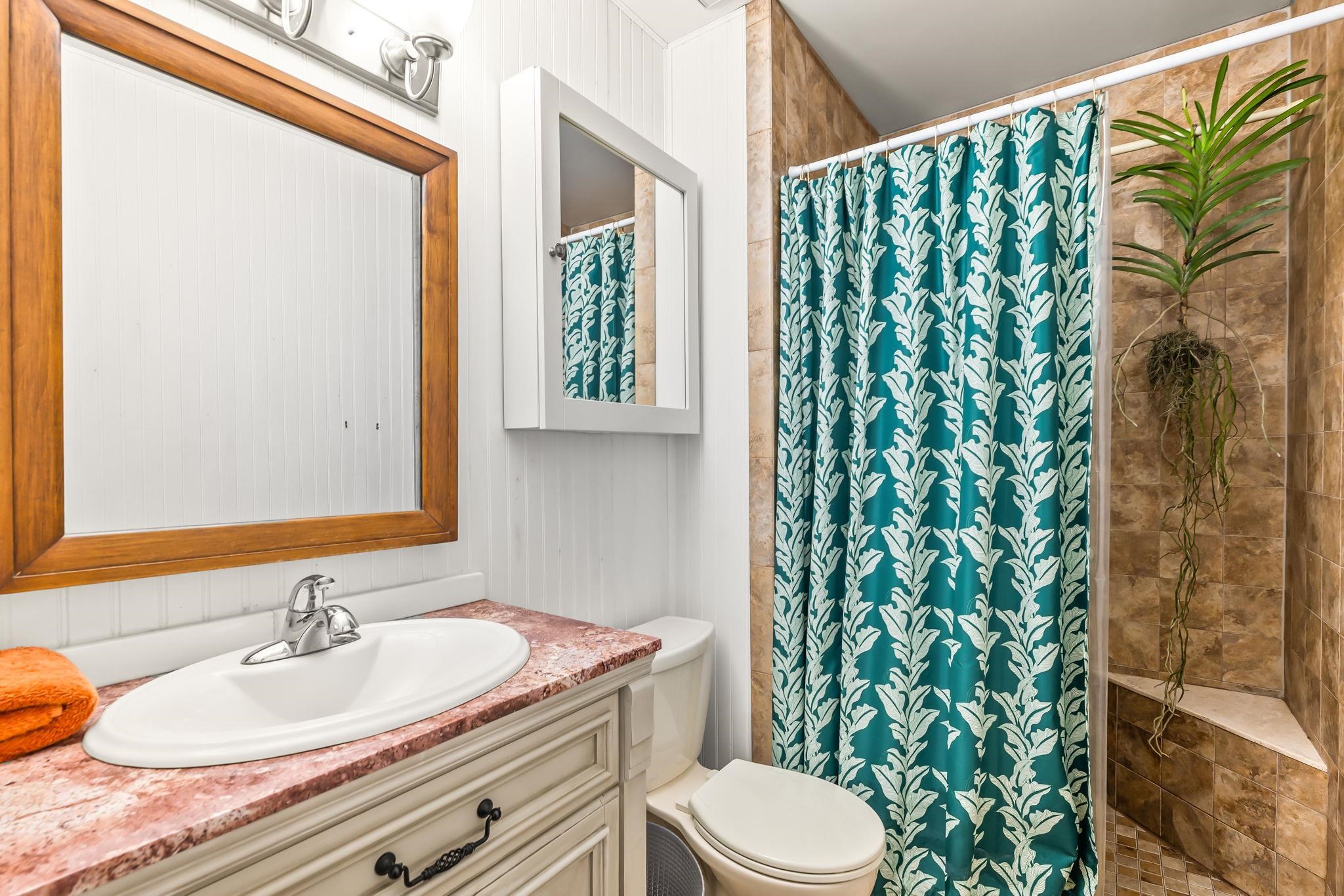 129 Pelican Road St. Augustine, FL 32086 - Photo 18 of 35 a bathroom with a granite countertop sink and a mirror