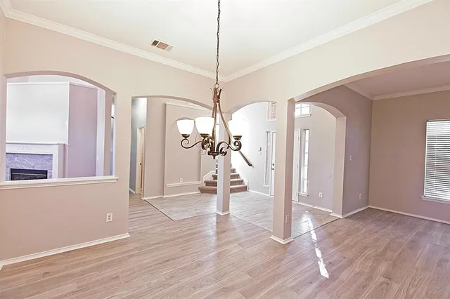 a large white kitchen with a refrigerator and white cabinets