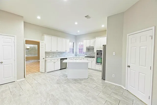 a hall with a sink a large mirror and a shower