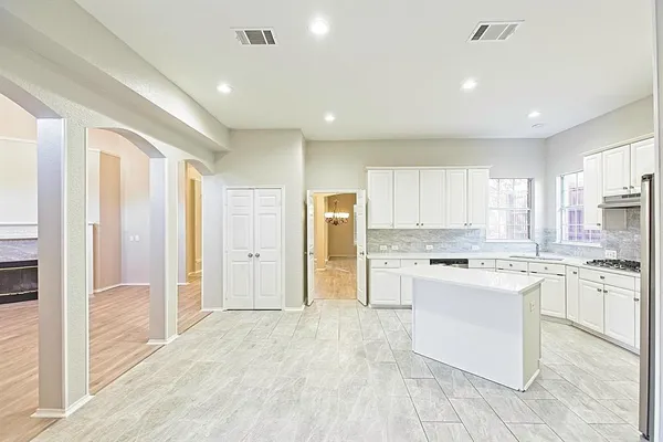 a view of empty room with wooden floor and fireplace