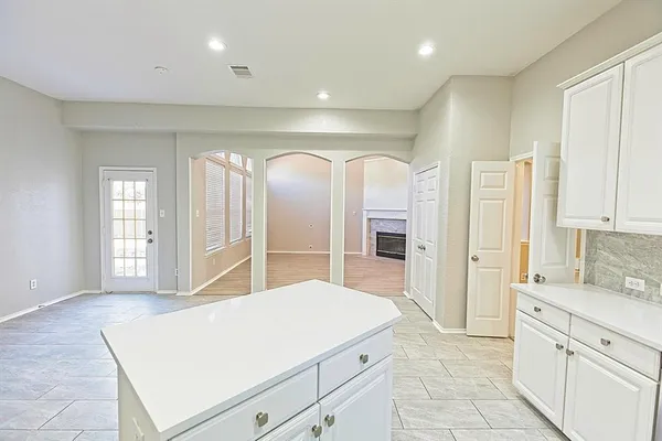 a view of a livingroom with wooden floor and a fireplace