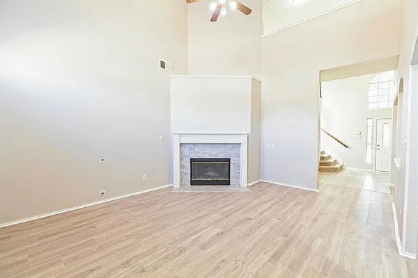 a view of a room with wooden floor and bathroom view