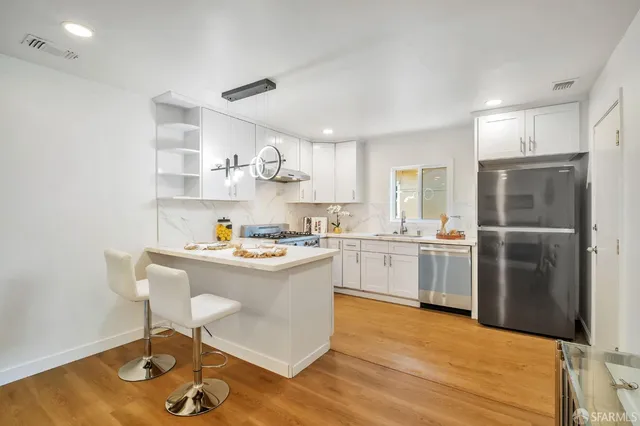 a kitchen with sink cabinets and stainless steel appliances