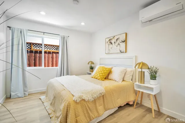 a bedroom with a bed and a painting on the wall