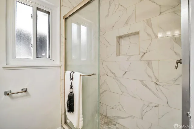 a bathroom with a shower and a mirror