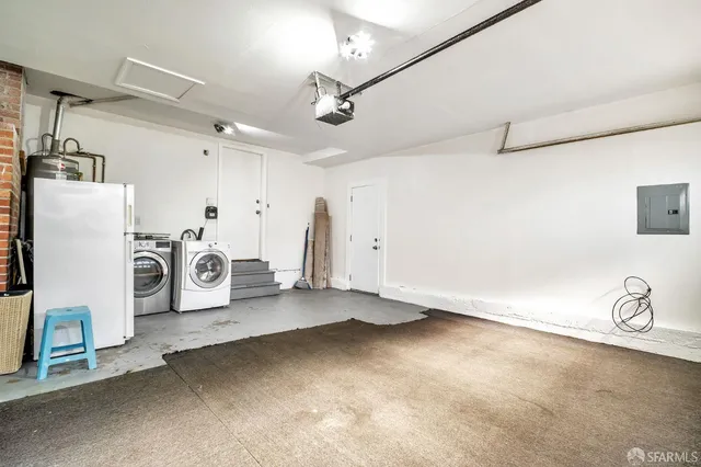 a view of a storage & utility room with two washing machine