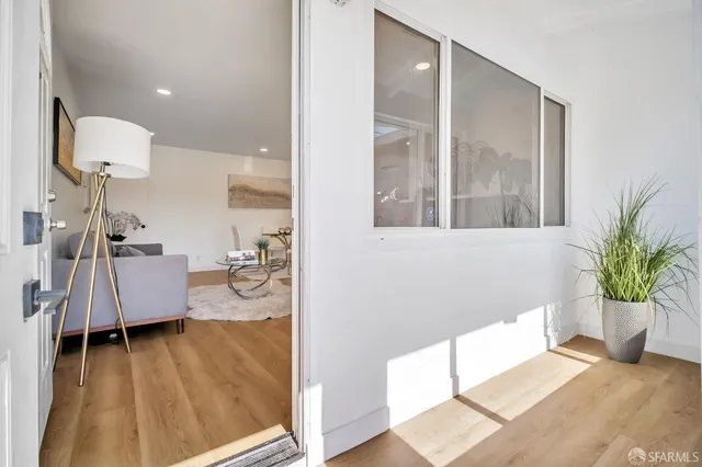 a living room with furniture and a potted plant