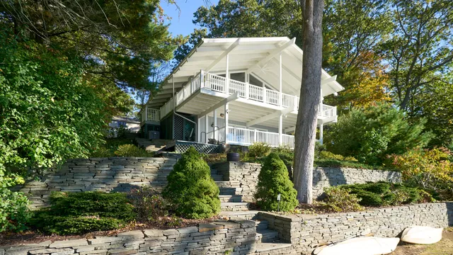 a large white kitchen with a large window