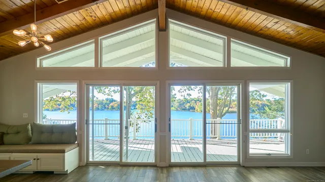 a living room with furniture and a floor to ceiling window