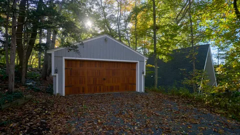 a front view of a house with a yard and tree s