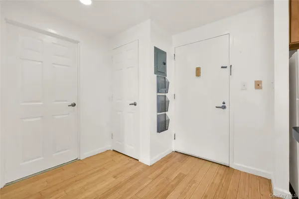 a view of an empty room with wooden floor