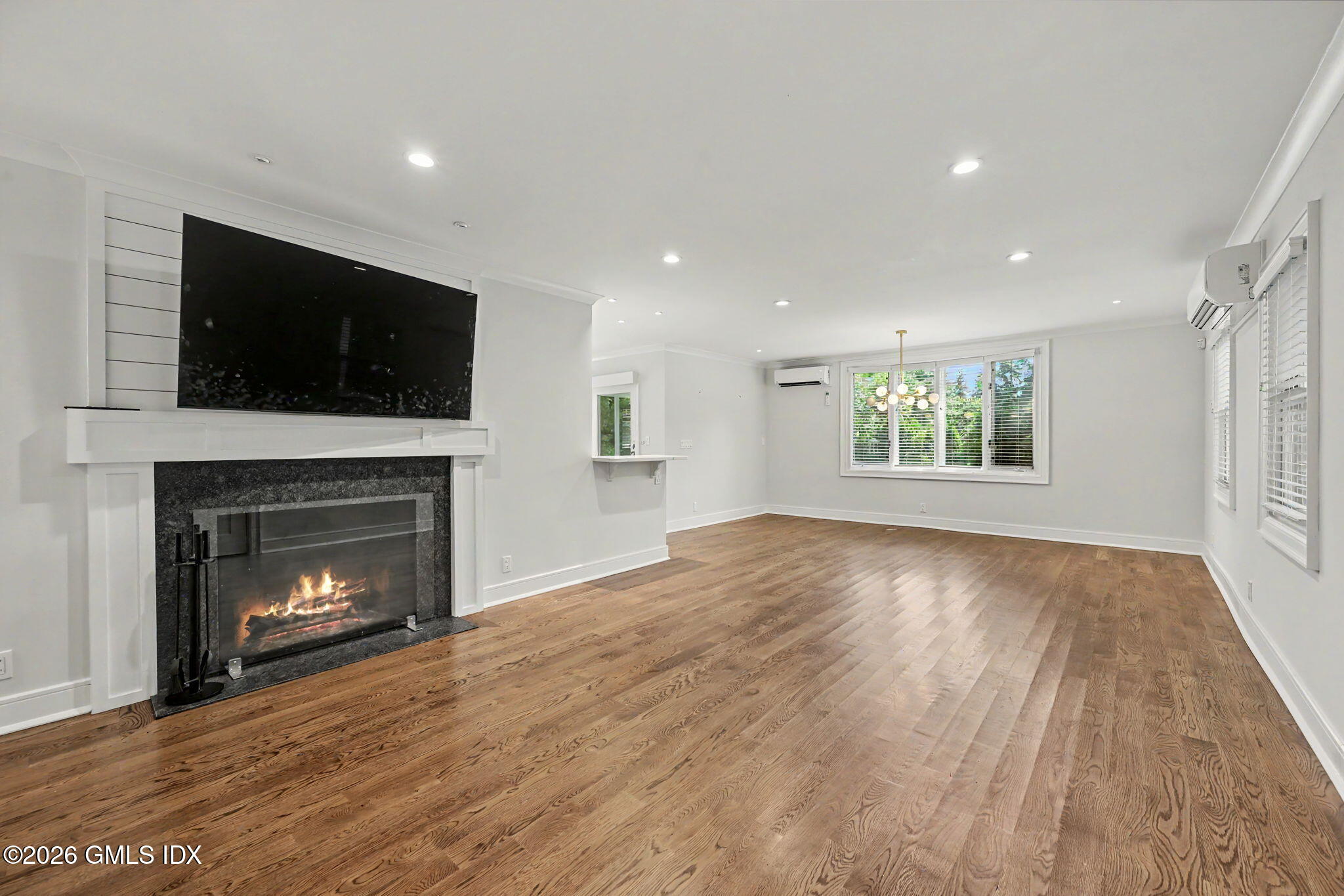 124 Shore Road Old Greenwich, CT 06870 - Photo 5 of 28 a view of an empty room with a fireplace and a window