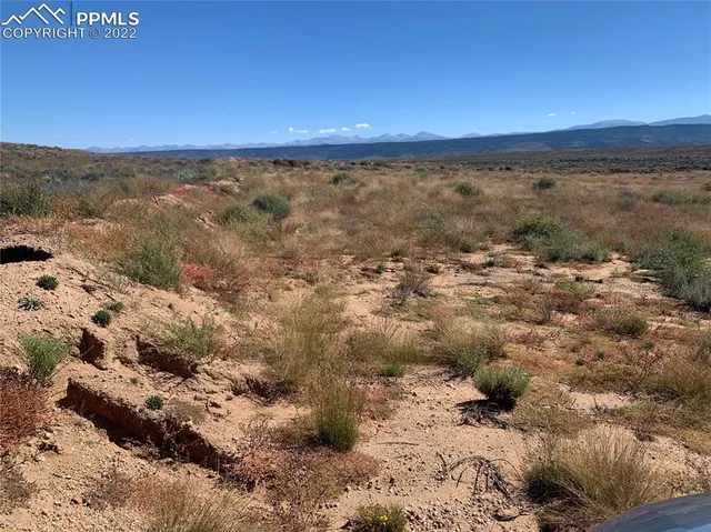 a view of mountain with wooden fence