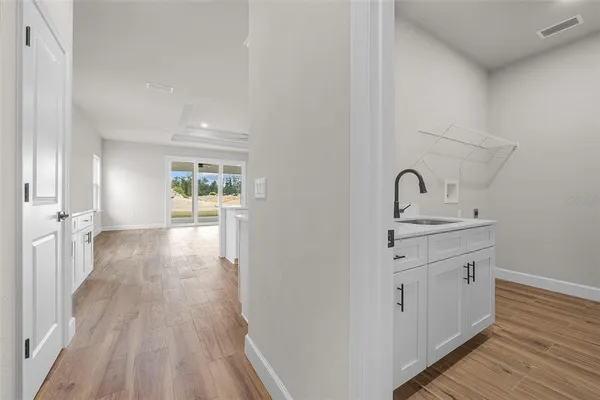 a view of a hallway with wooden floor