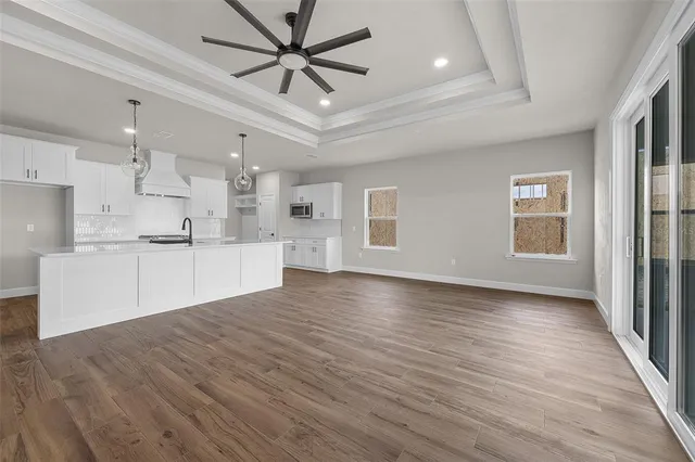 a view of a kitchen with wooden floor and a kitchen