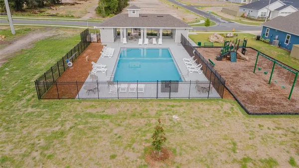 an aerial view of a house with outdoor space and lake view