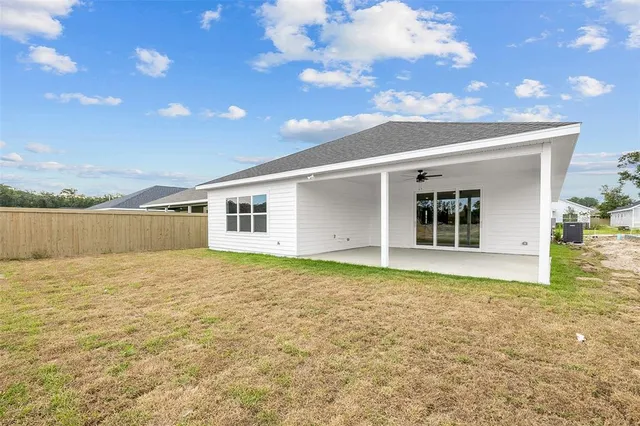 a view of an empty room with kitchen and mountain view