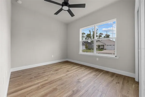 a view of a room with wooden floor and window