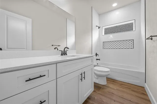 a bathroom with a double vanity sink toilet and shower