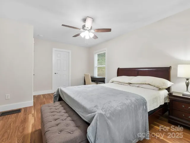 a bedroom with a bed and a chandelier