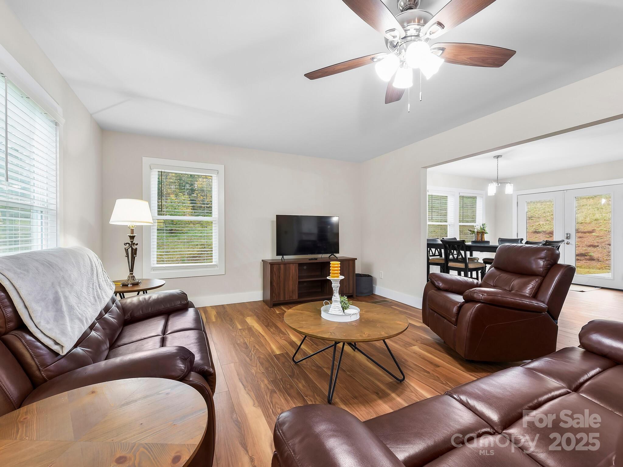 258 Old Weaverville Road Asheville, NC 28804 - Photo 7 of 25 a living room with furniture a flat screen tv and a large window