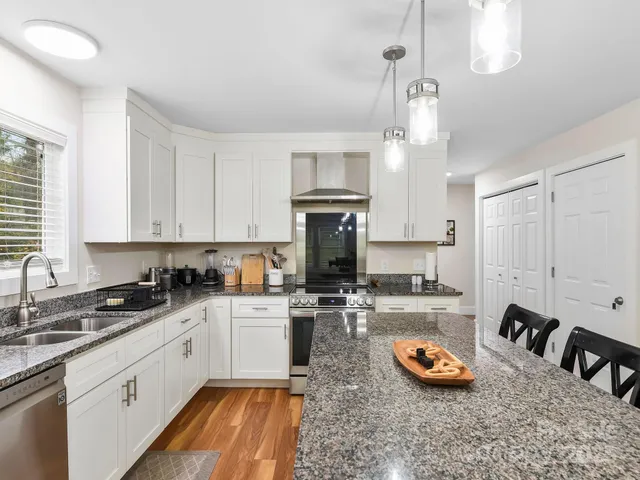 a kitchen with sink refrigerator and cabinets