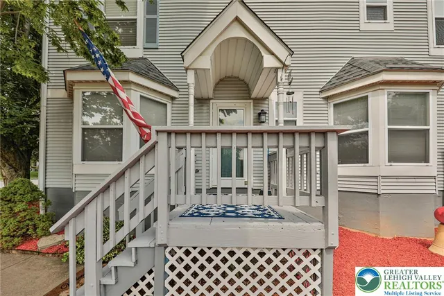 a view of a house with wooden fence